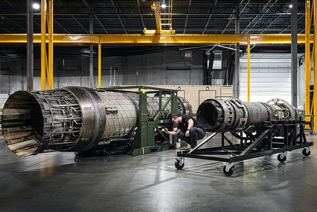 engineer conducting an inspection on jet engine