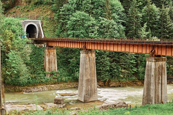 an old bridge leading into a railway tunnel