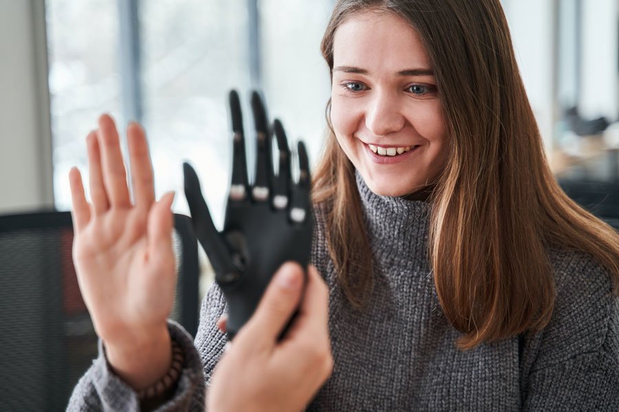 happy customer seeing custom prosthetic hand for the first time