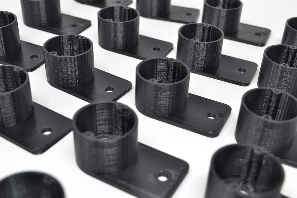 multiple rows of small black 3d printed cylinders