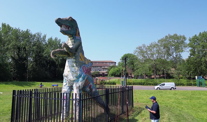 engineer conducting a 3D laser scan on the Milton Keynes dinosaur statue