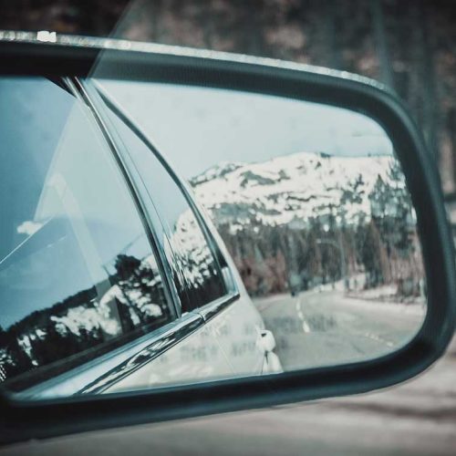 wing mirror showing rear of vehicle in reflection